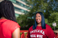 A social work faculty member talks to a student.